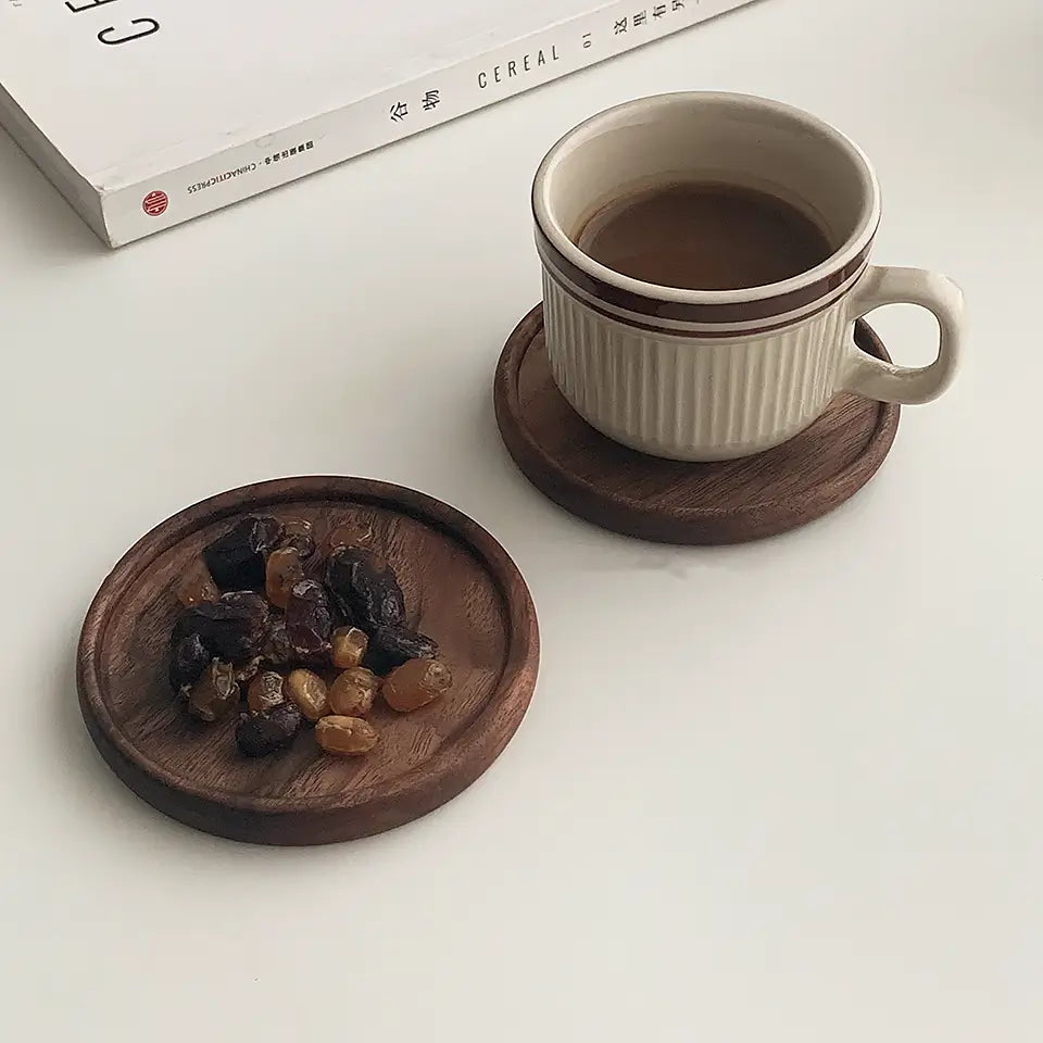 ForestCraft Round Japanese Walnut Coaster used to hold dried fruits and a coffee cup