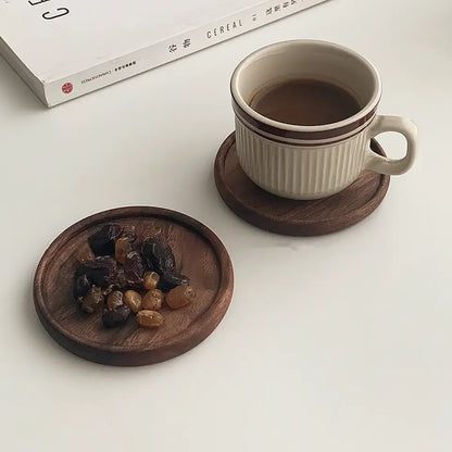 ForestCraft Round Japanese Walnut Coaster used to hold dried fruits and a coffee cup