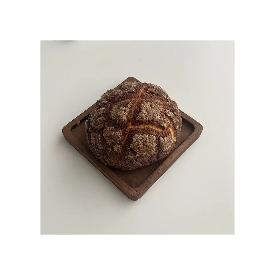ForestCraft Square Japanese Walnut Coaster used to hold a freshly baked roll