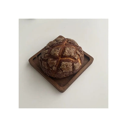 ForestCraft Square Japanese Walnut Coaster used to hold a freshly baked roll